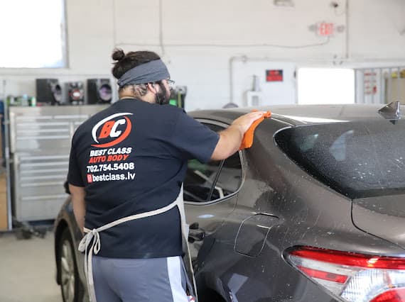 Technician polishing dark vehicle at Best Class Auto Body Las Vegas