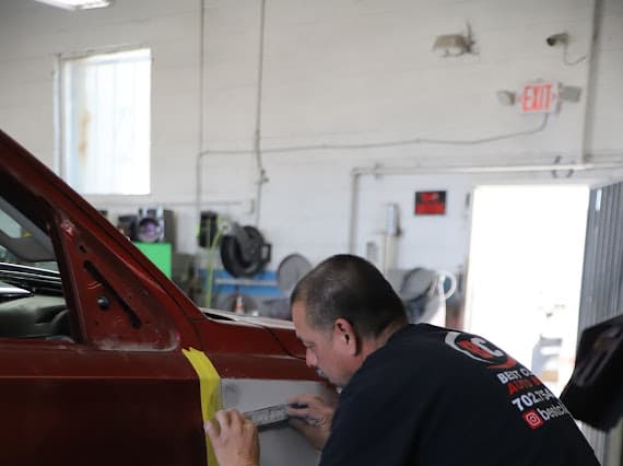 Red truck collision repair in progress at Best Class Auto Body Las Vegas