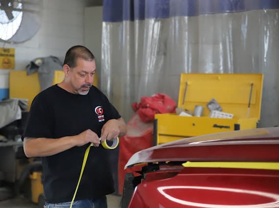 Technician performing collision damage assessment at Best Class Auto Body Las Vegas